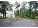 Wide driveway area with trees and partial view of neighboring house at 4011 Florida Ave, Atlanta, GA 30360