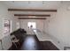 This living room features white walls, dark wood flooring, exposed beams, and ample space for versatile arrangements at 4011 Florida Ave, Atlanta, GA 30360