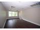 Large living room with hardwood floors, bright lighting, and natural light at 4011 Florida Ave, Atlanta, GA 30360