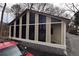 Cozy sunroom features a wall of tall windows, letting in ample natural light, perfect for relaxing and enjoying the view at 4011 Florida Ave, Atlanta, GA 30360