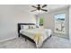 Carpeted bedroom with natural light from two windows overlooking the backyard at 579 Collections Dr, Lawrenceville, GA 30043