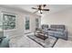 Inviting living room with gray sofas, balcony, and a stylish area rug at 579 Collections Dr, Lawrenceville, GA 30043