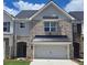 Charming townhome with a brick facade, gray accents, and a two-car garage, enhancing its curb appeal at 684 Sundial Ln, Mableton, GA 30126