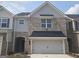 Charming two-story townhome with a brick and gray facade and a two-car garage at 684 Sundial Ln, Mableton, GA 30126