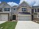 Attractive townhome with brick and siding, featuring a two-car garage and landscaped front yard at 684 Sundial Ln, Mableton, GA 30126