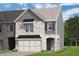 Charming two-story home with brick and siding, a two-car garage and manicured front lawn at 684 Sundial Ln, Mableton, GA 30126
