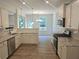 Bright kitchen featuring white cabinetry, granite countertops, stainless steel appliances, and hardwood floors at 684 Sundial Ln, Mableton, GA 30126