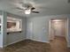 Open living room featuring hardwood floors, ceiling fan, and view into kitchen and staircase at 684 Sundial Ln, Mableton, GA 30126