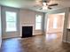 Cozy living room with fireplace, two large windows, light filled space, and wood flooring at 684 Sundial Ln, Mableton, GA 30126