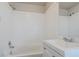 Bright bathroom showcasing tiled walls, vanity with sink, and tub at 1810 Oakmont Nw Dr, Atlanta, GA 30314