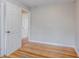 Cozy bedroom shows hardwood floors and an open door that leads to another room at 1810 Oakmont Nw Dr, Atlanta, GA 30314