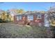 Side view of a single-story brick home featuring a lawn covered with leaves at 1810 Oakmont Nw Dr, Atlanta, GA 30314