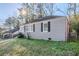 Single story home with gray brick and a small yard in a sunny setting at 1810 Oakmont Nw Dr, Atlanta, GA 30314
