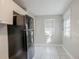 Small kitchen with white cabinets and black refrigerator, with natural light at 1810 Oakmont Nw Dr, Atlanta, GA 30314
