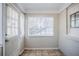 Bright sunroom with tile flooring, white trim, and walls at 1810 Oakmont Nw Dr, Atlanta, GA 30314