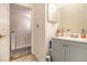 Bathroom with a gray vanity, decorated mirror and view to the staircase at 4526 Golf Vista Cir, Decatur, GA 30035