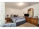 Bright bedroom features a bed, full dresser with mirror, side table and gray chair at 4526 Golf Vista Cir, Decatur, GA 30035