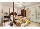 Bedroom featuring a four poster bed, chest of drawers and exterior access at 4526 Golf Vista Cir, Decatur, GA 30035