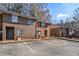 Brick townhome features a traditional design with a front parking lot on a sunny day at 4526 Golf Vista Cir, Decatur, GA 30035