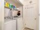 Bright laundry room with washer, dryer, shelving, and a white door at 4526 Golf Vista Cir, Decatur, GA 30035