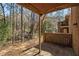 Covered patio with a view of the backyard trees and brick exterior at 4526 Golf Vista Cir, Decatur, GA 30035