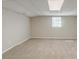 A cozy carpeted basement offers a bright and open space with a window at 5498 Balmoral Dr, Douglasville, GA 30135