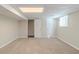 A view of the carpeted basement with a drop ceiling, two windows, and a closet at 5498 Balmoral Dr, Douglasville, GA 30135