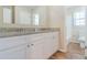 Bright bathroom with a double vanity, granite countertop, and wood-look flooring at 5498 Balmoral Dr, Douglasville, GA 30135
