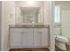 Bathroom featuring granite countertops, white cabinets, and tile flooring near the toilet and shower at 5498 Balmoral Dr, Douglasville, GA 30135