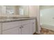 Bathroom featuring granite counters, white cabinets, and a bathtub with shower at 5498 Balmoral Dr, Douglasville, GA 30135