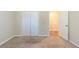 Bedroom featuring plush carpet, closet with bi-fold doors, and access to an adjacent room at 5498 Balmoral Dr, Douglasville, GA 30135