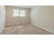 Neutral carpeted bedroom bathed in natural light from a large window at 5498 Balmoral Dr, Douglasville, GA 30135