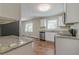 This kitchen boasts granite counters, stainless appliances, white cabinets, and wood-look flooring at 5498 Balmoral Dr, Douglasville, GA 30135