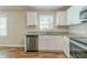 Bright kitchen with granite countertops, stainless steel appliances, and modern white cabinetry at 5498 Balmoral Dr, Douglasville, GA 30135