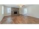 Spacious living room boasts hardwood floors, a brick fireplace, and plenty of room for entertaining guests at 5498 Balmoral Dr, Douglasville, GA 30135