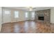 Bright living room features a cozy brick fireplace, hardwood floors, and large windows for natural light at 5498 Balmoral Dr, Douglasville, GA 30135