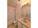Bathroom with a tub and shower combination, vanity, and ample lighting at 682 New England Way, Lawrenceville, GA 30046