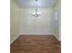 Bright dining area featuring wood floors and a modern chandelier at 682 New England Way, Lawrenceville, GA 30046