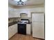 Efficient kitchen with tile floors, granite countertops, and white cabinets at 682 New England Way, Lawrenceville, GA 30046