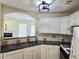 Functional kitchen with stainless steel sink, granite counters, and white cabinets at 682 New England Way, Lawrenceville, GA 30046