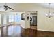 Open living room with wood floors, natural light, and a view of the kitchen at 682 New England Way, Lawrenceville, GA 30046