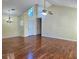 Well-lit living room with vaulted ceilings, hardwood floors, and modern light fixtures at 682 New England Way, Lawrenceville, GA 30046