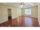 Spacious main bedroom with wood floors, a ceiling fan, and natural light at 682 New England Way, Lawrenceville, GA 30046
