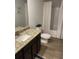 Bathroom showcasing a granite countertop vanity, toilet, and a shower with patterned curtains at 745 Great Oak Pl, Villa Rica, GA 30180