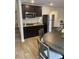 Kitchenette with stainless steel microwave, sink and refrigerator, complemented by dark cabinetry at 745 Great Oak Pl, Villa Rica, GA 30180