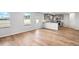 Bright, open-concept living room with hardwood floors leads into a modern kitchen at 745 Great Oak Pl, Villa Rica, GA 30180