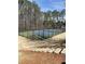 Community tennis court surrounded by tall trees and equipped with fencing at 745 Great Oak Pl, Villa Rica, GA 30180