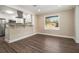 Open dining area featuring hardwood floors, a large window and flowing seamlessly into the modern kitchen at 1961 S Columbia, Decatur, GA 30032