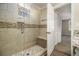 Modern shower with a glass door, decorative tile, built-in bench, and easy access to the adjacent bathroom at 1961 S Columbia, Decatur, GA 30032
