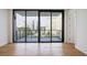A balcony view of the city skyline, with black framed doors and wood floors at 2425 Peachtree Ne Rd # 903, Atlanta, GA 30305